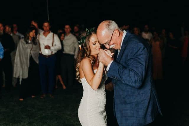 When time came for the father-daughter dance, instead Ms Young danced with seven of Mr Young's colleagues to Paul Simon's Father And Daughter.