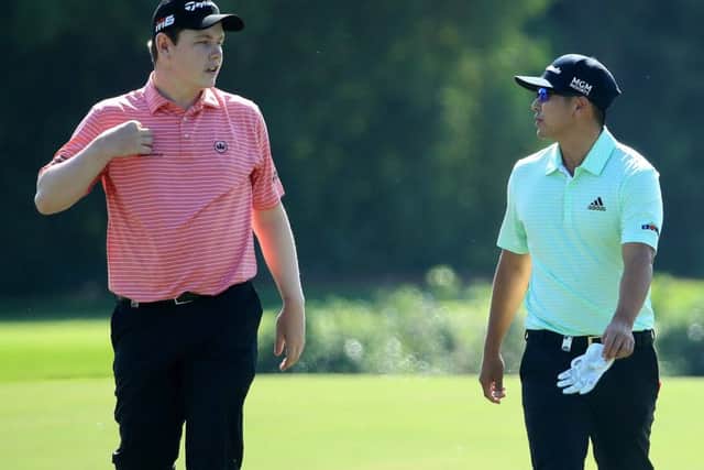 Bob MacIntyre and European Tour Rookie of the Year rival Kurt Kitayama chat walking up the third fairway on the Greg Norman-designed Earth Course in Dubai. Picture: Getty Images