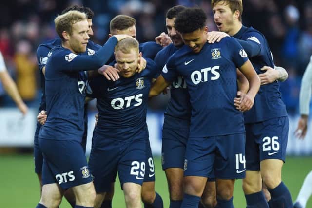 Killie winger Chris Burke, centre, celebrates his second goal against Hearts at Rugby Park. Picture: SNS