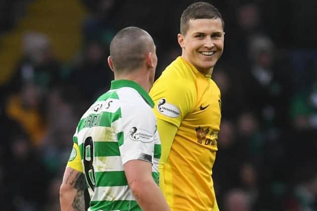 Celtic's Scott Brown exchanges words with Livingston striker Lyndon Dykes during the match between the sides at Celtic Park on Saturday. Picture: SNS