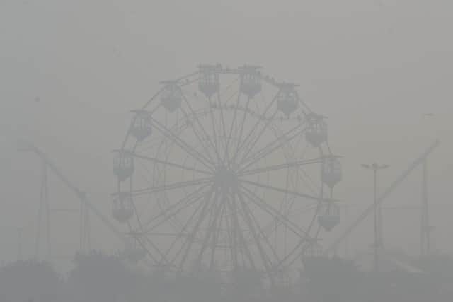 A ferris wheel amid heavy smog conditions in Lahore (Picture: Arif Ali/AFP via Getty Images)