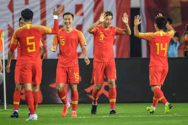 Chinese players (L-R) Zhang Linpeng (#5), Wu Xi, Yang Xu and Chi Zhongguo celebrate a goal during the World Cup 2022 qualifier football match between China and Guam in Guangzhou on October 10, 2019. (Photo by STR / AFP) / China OUT (Photo by STR/AFP via Getty Images)