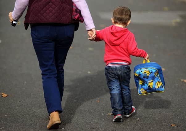 Working parents need to balance the demands of their job with ensuring their children are well looked after (Picture: Brian Lawless/PA)