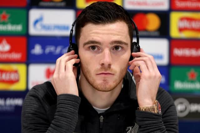 Liverpools Andy Robertson dons headphones to answer questions from Italian journalists at an Anfield press conference. Picture: Richard Sellers/PA Wire