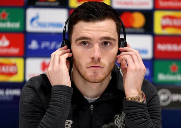 Liverpools Andy Robertson dons headphones to answer questions from Italian journalists at an Anfield press conference. Picture: Richard Sellers/PA Wire