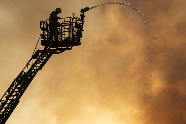 Firefighters are still battling the blaze, which broke out shortly before 1pm this afternoon. A roof is said to have collapsed at the school, where the art department and a sports hall are thought to have been severely damaged. Picture: Gareth Easton