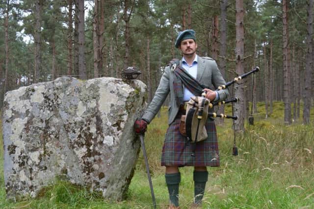 Iain MacGillivray is Scotland's youngest leader of clan. He is pictured at Clach An Airm, or Stone of the Swords near Gask, where his clansmen met before going to the Battle of Culloden in 1746. PIC: Iain Thornber.