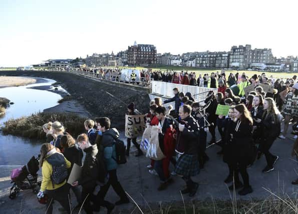 Climate marchers head for the beach in St Andrews. Picture: Lisa Ferguson