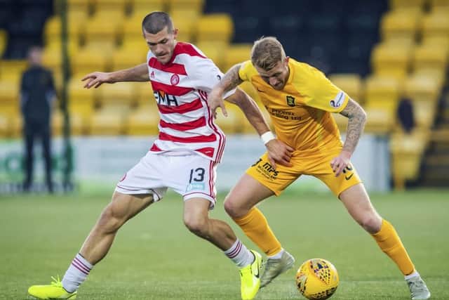 Livingston's Robbie Crawford, right, and Hamilton's Alex Gogic jostle for possession. Picture: Roddy Scott / SNS
