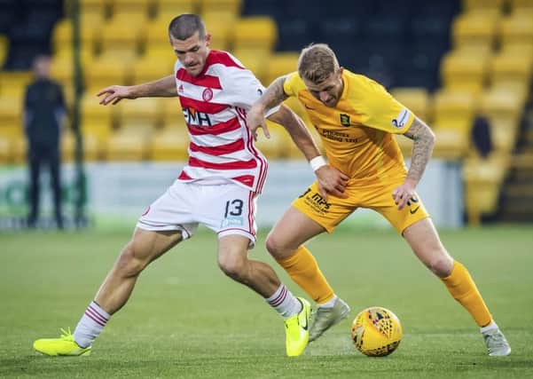 Livingston's Robbie Crawford, right, and Hamilton's Alex Gogic jostle for possession. Picture: Roddy Scott / SNS