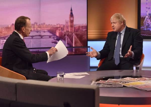 Prime Minister Boris Johnson speaks with political journalist Andrew Marr.  Photo: JEFF OVERS/ AFP
