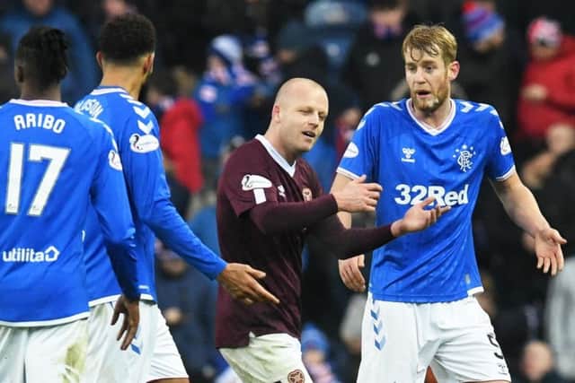 Hearts striker Steven Naismith exchanges words with Rangers Filip Helander. Picture: Craig Foy/SNS