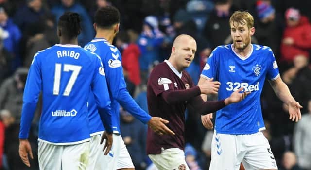 Hearts striker Steven Naismith exchanges words with Rangers Filip Helander. Picture: Craig Foy/SNS