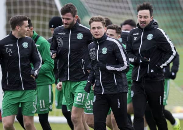 Jason Naismith and Scott Allan lead the Hibs players at training ahead of Wednesday night's game against Ross County. Picture: Bruce White/SNS
