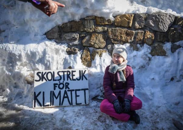 Greta Thunberg sits with a placard reading school strike for climate outside the World Economic Forums meeting in Davos in January (Picture: Fabrice Coffrini/AFP via Getty Images)