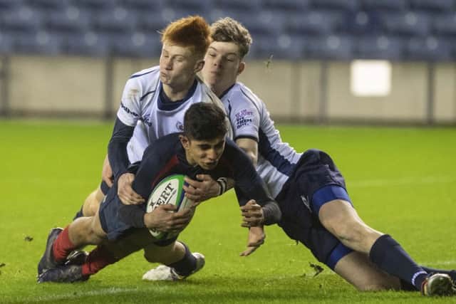 Merchiston winger Amaan Raza scores one of his two tries against Dollar Academy in the under-16 Cup final at BT Murrayfield. Picture: Paul Devlin/SNS/SRU