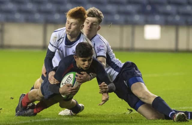 Merchiston winger Amaan Raza scores one of his two tries against Dollar Academy in the under-16 Cup final at BT Murrayfield. Picture: Paul Devlin/SNS/SRU