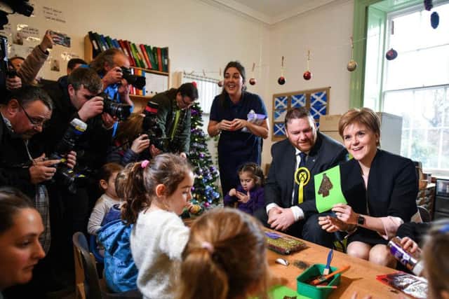 Nicola Sturgeon makes Christmas cards with children, during a visit to Happy Days Nursery with Owen Thompson, SNP candidate for Midlothian. Picture: Getty Images