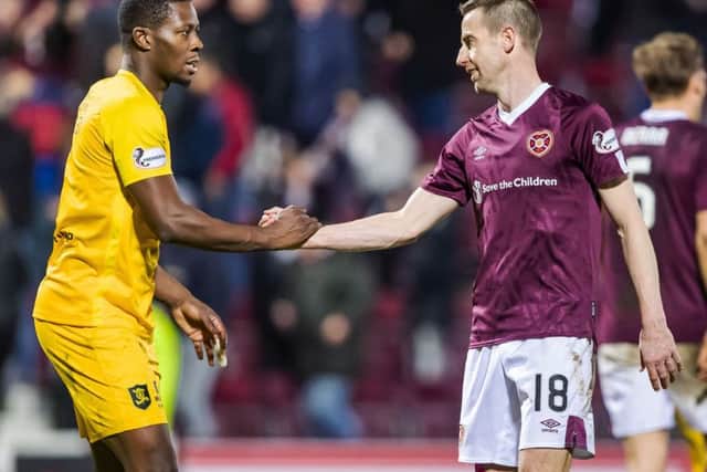 Hearts goalscorer Steven MacLean shakes hands with Livingston's Marvin Bartley who was also on target in the 1-1 draw at Tynecastle. Picture: Roddy Scott/SNS