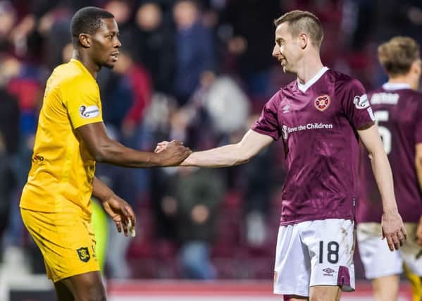 Hearts goalscorer Steven MacLean shakes hands with Livingston's Marvin Bartley who was also on target in the 1-1 draw at Tynecastle. Picture: Roddy Scott/SNS
