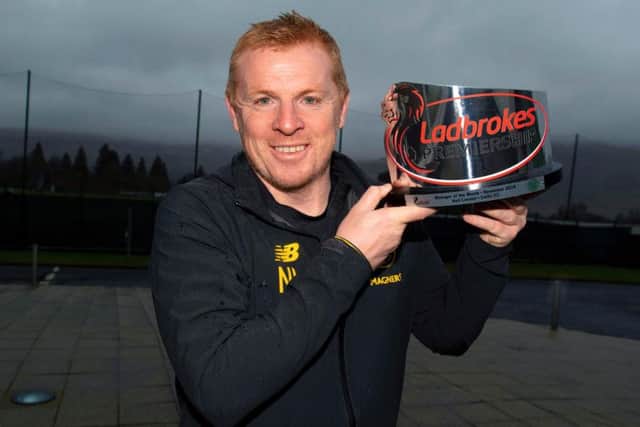 Neil Lennon shows off the award at Lennoxtown