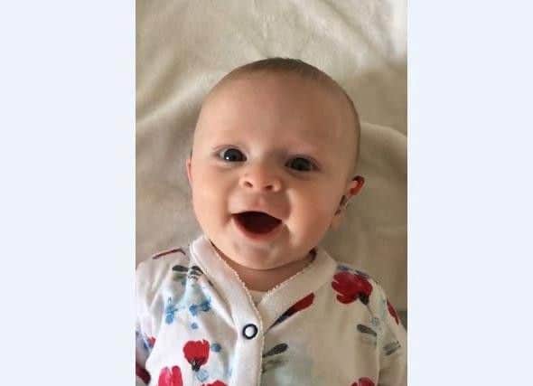 Georgina Addison, who is four-months-old, was born severely deaf. Picture: SWNS