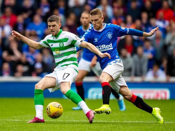 Ryan Christie and Steven Davis compete during the Old Firm game in September.