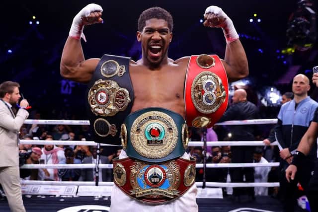 Anthony Joshua gets reacquainted with the IBF, WBA, WBO & IBO World Heavyweight Title belts after his victory over Andy Ruiz Jr in Saudi Arabia. Picture: Richard Heathcote/Getty Images