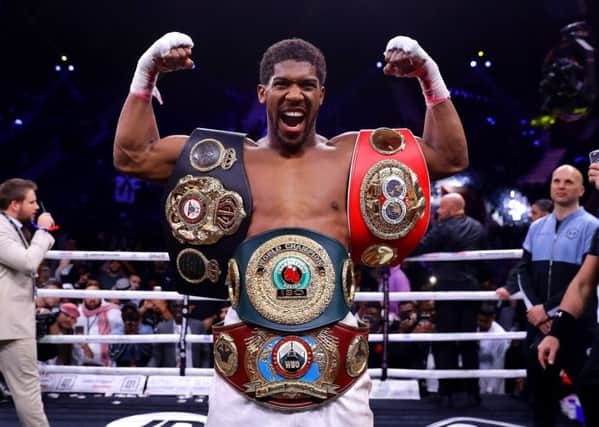 Anthony Joshua gets reacquainted with the IBF, WBA, WBO & IBO World Heavyweight Title belts after his victory over Andy Ruiz Jr in Saudi Arabia. Picture: Richard Heathcote/Getty Images