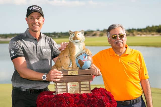 Henrik Stenson, left, poses with the trophy alongside Dr Pawan Munjal, the chairman at Hero MotoCorp, after winning the World Challenge in Nassau.