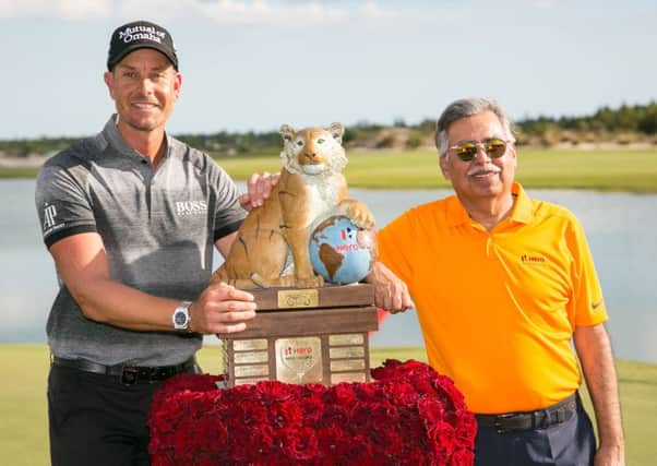 Henrik Stenson, left, poses with the trophy alongside Dr Pawan Munjal, the chairman at Hero MotoCorp, after winning the World Challenge in Nassau.