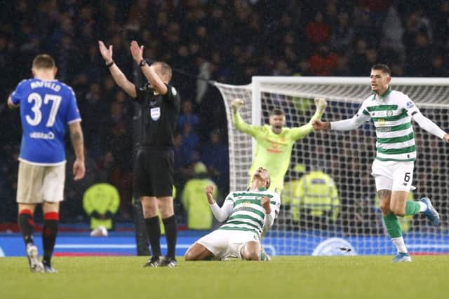 Scott Brown sinks to the turf in ecstasy as Nir Button and Fraser Forster race to join in at the final whistle. Picture: PA