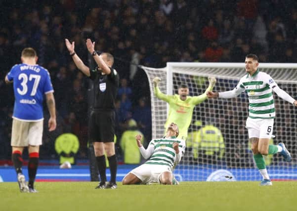 Scott Brown sinks to the turf in ecstasy as Nir Button and Fraser Forster race to join in at the final whistle. Picture: PA