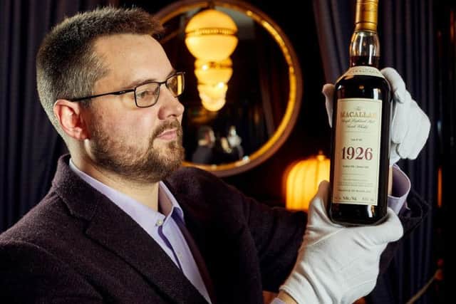 Whisky Auctioneer's Iain McClune with one of the most valuable bottles.