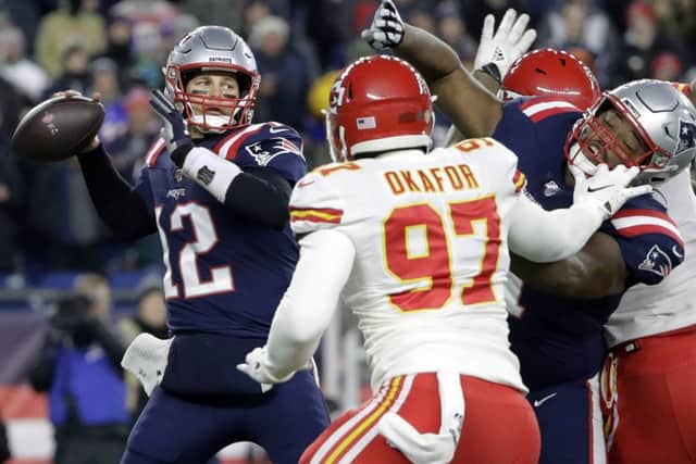 New England Patriots quarterback Tom Brady passes under pressure from the Chiefs Alex Okafor. Picture: AP.