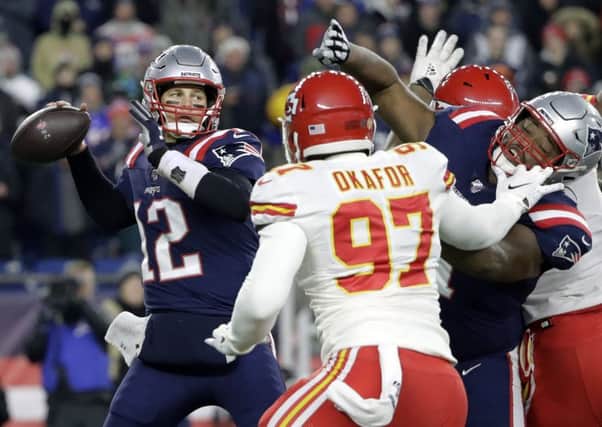 New England Patriots quarterback Tom Brady passes under pressure from the Chiefs Alex Okafor. Picture: AP.