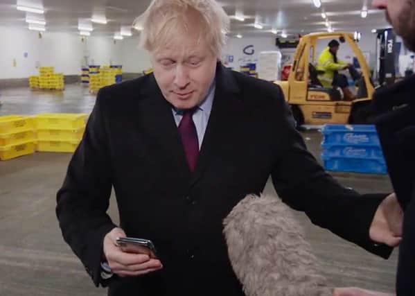 Boris Johnson did eventually look at a photograph of a four-year-old boy with suspected pneumonia sleeping on the floor in a hospital because of a shortage of beds on the phone of ITV reporter Joe Pike, after initially putting it in his pocket (Picture: ITV/PA Wire)