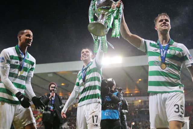 Ryan Christie holds aloft the Betfred trophy with Kristoffer Ajer.