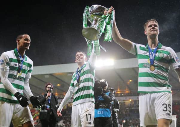 Ryan Christie holds aloft the Betfred trophy with Kristoffer Ajer.
