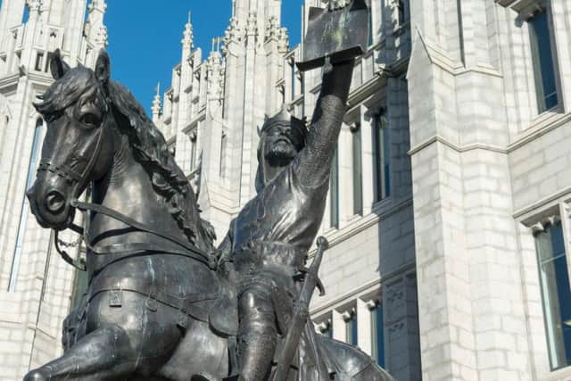 A statue of Robert the Bruce holding the Stocket Charter outside Marischal College in Aberdeen. PIC: Aberdeen City Council.