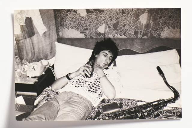 Ronnie asleep with a beer and his saxophone