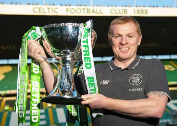 Neil Lennon was all smiles  as he paraded the Betfred Cup trophy in front of the media at Parkhead.