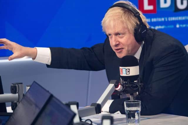 Prime Minister Boris Johnson makes a point on LBC radio