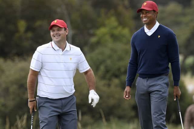 Patrick Reed, left, and US captain Tiger Woods during practice ahead of the Presidents Cup in Melbourne. Picture: Andy Brownbill/AP