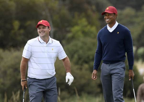 Patrick Reed, left, and US captain Tiger Woods during practice ahead of the Presidents Cup in Melbourne. Picture: Andy Brownbill/AP