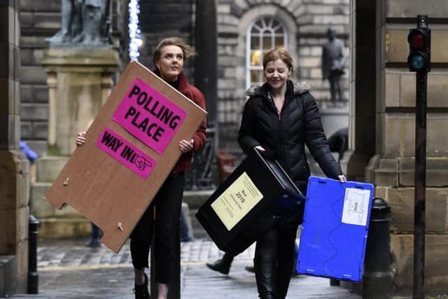 Staff walk up the Royal Mile ahead of Thursday's election day