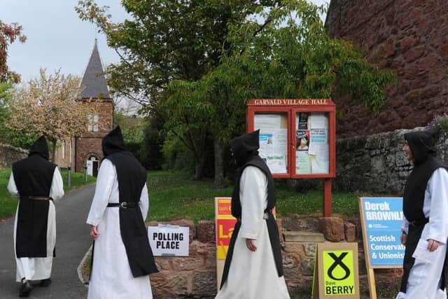 Monks from Nunraw Abbey in East Lothian arrive to vote at the village polling station at the 2011 Scottish elections. Just four seats north of the Border are considered safe. Picture: Neil Hanna/TSPL
