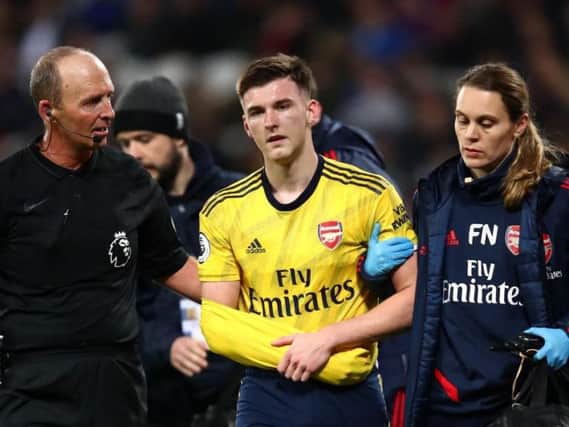 Kieran Tierney is helped off the park after falling awkwardly during Arsenal's Premier League clash with West Ham at the London Stadium