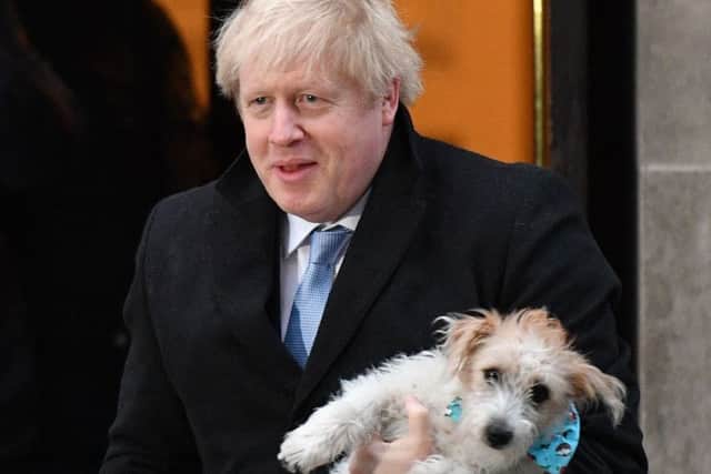 Britain's Prime Minister Boris Johnson poses with his dog Dilyn as he leaves from a polling station. Picture: Daniel Leal-Olivas/AFP via Getty Images