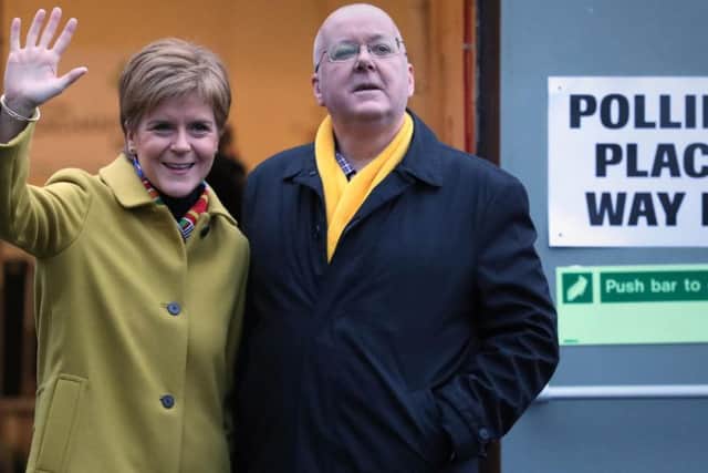 Nicola Sturgeon with husband Peter Murrell as they cast their votes at Broomhouse Park Community Hall today. Picture: PA